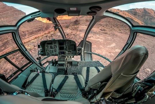 The cockpit of a Maverick Airbus helicopter with the majestic view of the Grand Canyon below them.