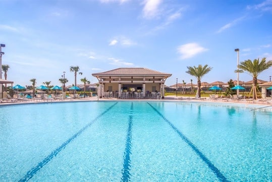 Championsgate Resort by Global Vacation Rentals' outdoor clubhouse pool and cabanas.