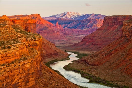 The beautiful scenery of the Colorado River and the surrounding canyon and mountains on the Colorado River Full-Day Rafting Adventure in Moab Utah.