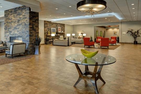 The beautifully decorated lobby of the DoubleTree by Hilton Hotel Flagstaff with two sitting areas and two rock fireplaces.