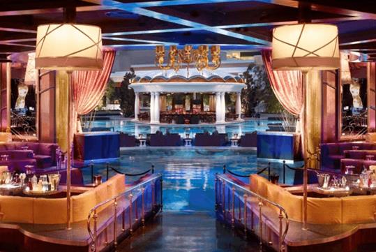 The luxurious XS Nightclub decorated in gold and deep purple surrounding Encore's European pool in Las Vegas.