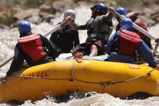 Guests are in awe of the Colorado River while riding their inflatable kayaks.