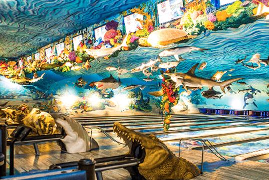 An ocean themed bowling alley with sharks hanging from the ceiling and bowling balls coming out of animals mouths at Fun Mountain at Big Cedar Lodge.