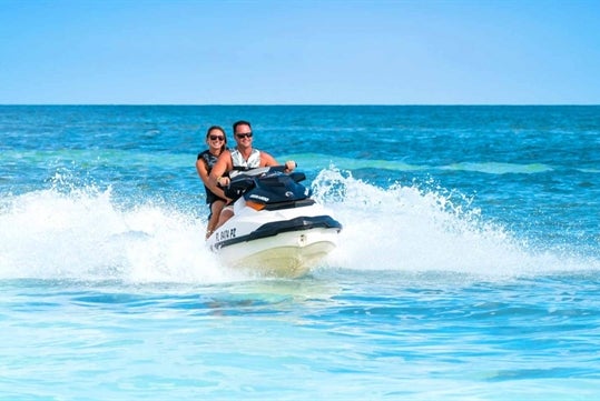 A couple riding a Jet ski on the Fury Water Adventure Ultimate Jet Ski Tour of Key West.