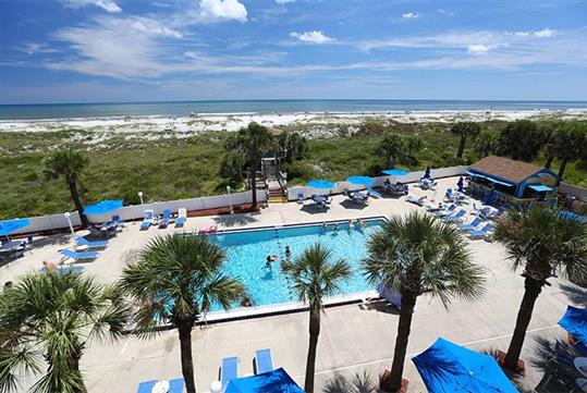 Outdoor pool, pool chairs and umbrellas, pool bar and direct access to the beach at Guy Harvey Resort.