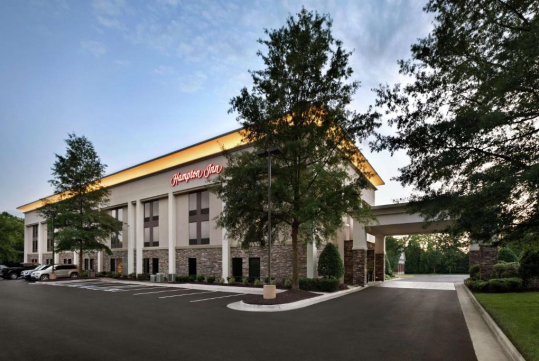 Hotel exterior surrounded with trees.