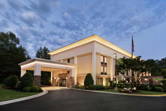 Hotel exterior surrounded with trees.