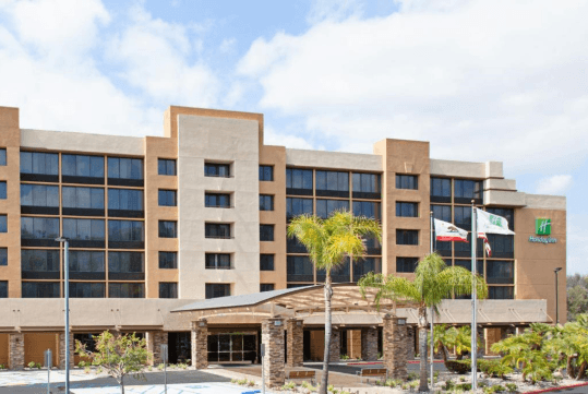 Hotel exterior with parking space.