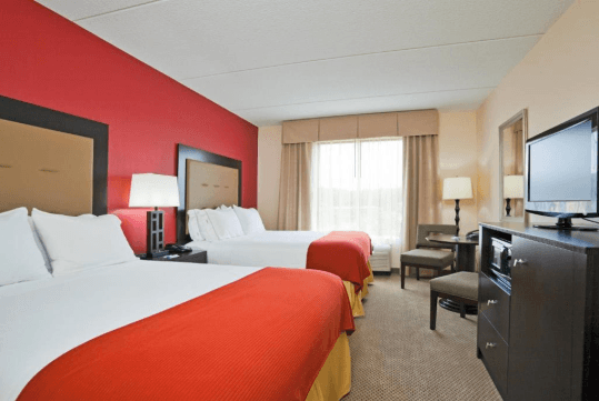 Guest room with 2 queen beds, flat-screen TV, desk and microwave at Holiday Inn Express Hotel & Suites Kodak East-Sevierville, an IHG Hotel, TN. 