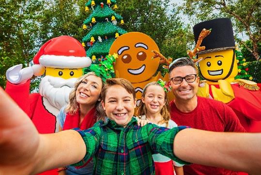 A family taking a selfie with Legoland characters at LEGOLAND Florida Resort.