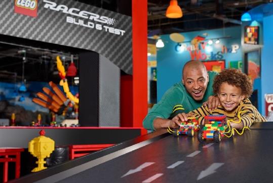 A father and son playing with LEGO cars at LEGOLAND® Discovery Center in Columbus, Ohio