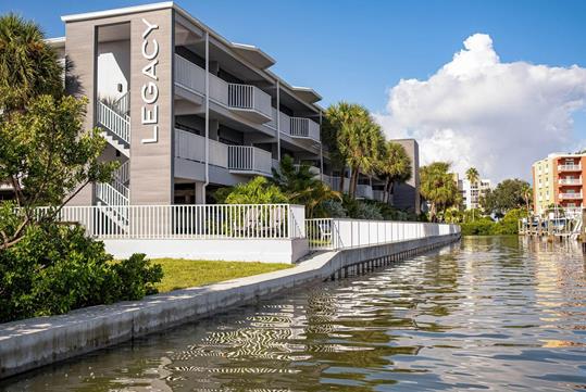 View of Legacy Vacation Resorts from the boat slip area behind the resort on a sunny day.