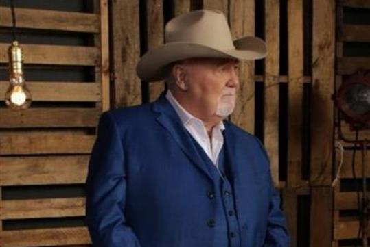 Johnny Lee in a blue suit and cowboy hat