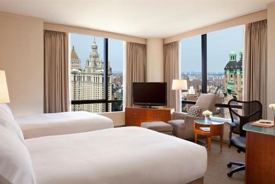 2 Double beds, city view, flat-screen TV, work desk, chair at Millennium Hotel, NY.
