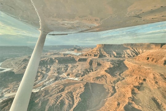 The rocky and sloping landscape on the Moab's Best Arches National Park Airplane Tour in Moab Utah, USA.