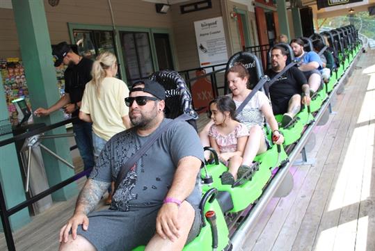 Four guests wait to take off on the Moonshine Mountain Coaster