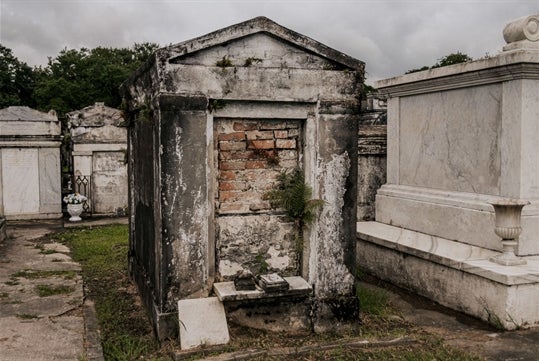 One of the crypts in Lafayette cemetery on the New Orleans Garden District Tour: Private Mansion Access, Lafayette Cemetery & Local Praline Maker Tour in New Orleans, Louisiana, USA.