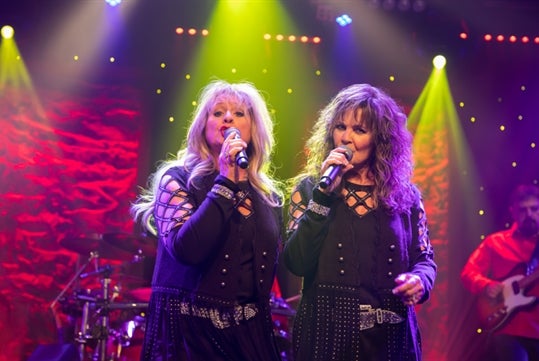 Two female singers performing on stage at the Ozarks Country show in Branson.