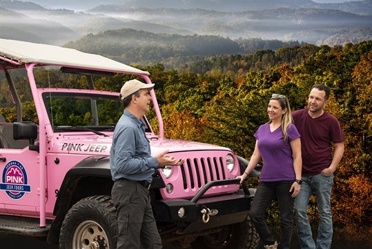 the tour guide talking with a couple of guess on the Foothills Parkway - Pink Jeep Tours in Pigeon Forge, Tennessee