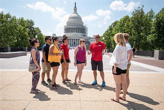 A group in front of the US Capitol Building about to kick-off their Politics and Pints walking tour of the historic Capitol Hill neighborhood.