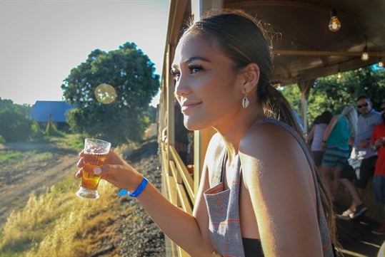 Woman enjoying a drink on the train in West Sacramento, California.