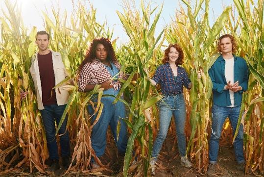 Four people in standing in a cornfield from the Broadway musical Shucked in NYC, New York.