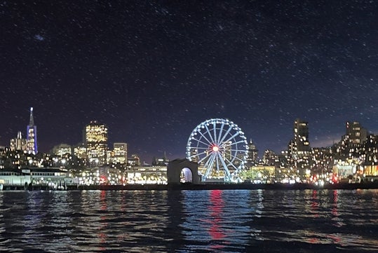 SkyStar Wheel Fisherman's Wharf at night with San Francisco skyline