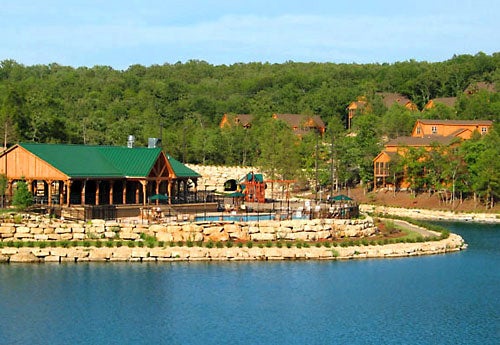 View of the pavilion and pool from across Fox Hollow Lake - StoneBridge Resort in Branson West, Missouri