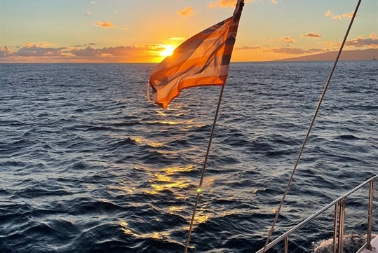 Cruising on the ocean while watching the sunset in Waikiki, Hawaii.