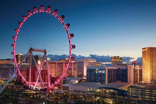 The High Roller ferris wheel and the LINQ Hotel and Casino at dusk with a mostly clear sky in Las Vegas, Nevada.