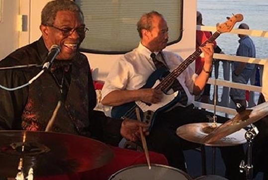 A group of musicians playing and having a good time on the Paddlewheeler Creole Queen Jazz Cruise.