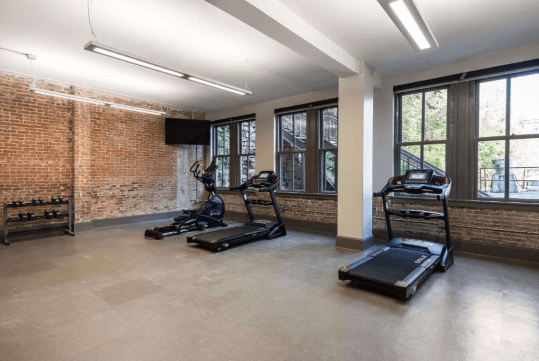 Fitness facilities with cardio equipment and weights.