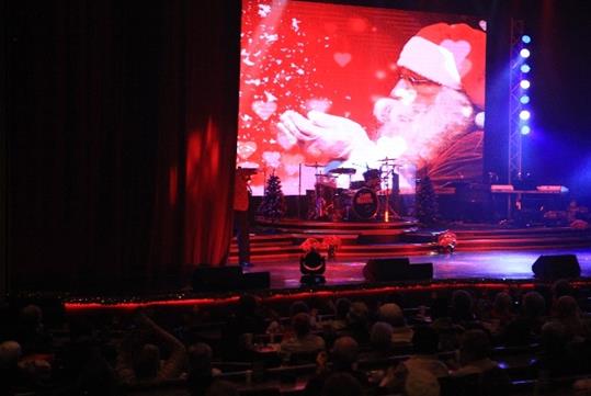 Audience looks on as Santa appears on the 40-foot LED screen on stage at America’s Hit Parade – Tis the Season at Grand Majestic Theater in Pigeon Forge, TN.