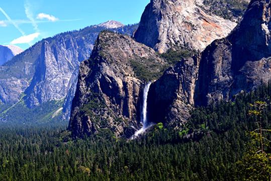 Wide shot of the Bridal Veil Falls waterfall on a sunny day on the Total Yosemite Experience in San Francisco, California.
