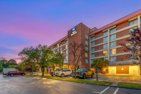 Hotel exterior at dusk.