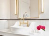 Sink and toiletries inside a guest bathroom.