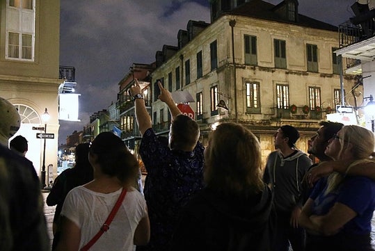 People pointing while on Witches, Ghosts, Vampires and Walking Tour