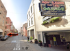 A street view of Bienville St. showing the Montleone Hotel Garage entrance on the right; a car is parked on the left, marked by a red arrow.