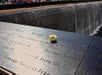 A small flower on a plaque on the 9/11 Memorial Tour & Priority Entrance 9/11 Museum Tickets Tour in New York City, New York, USA.