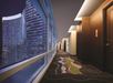 Hallways to the rooms with large windows with views of the city.