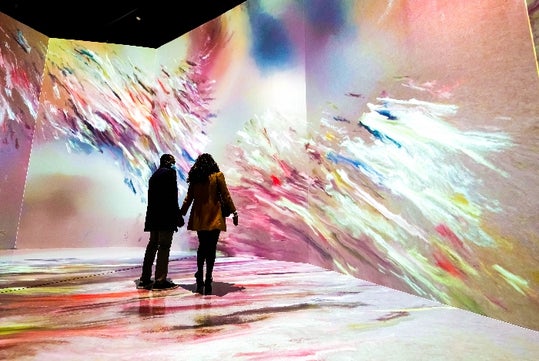 A couple looking at the artwork at ARTECHOUSE, Washington DC.