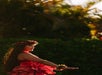 A hula dancer in traditional Hawaiian attire performing during the Grand Wailea Luau in Wailea, HI.
