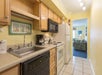 Full kitchen with a sink, dishwasher, stovetop, microwave, oven, refrigerator, and a coffee maker.
