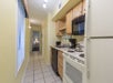 Full kitchen with stovetop, microwave, oven, coffee maker, toaster and a full-sized refrigerator.