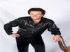Travis James in a black suit posing at A Tribute to Conway Twitty by Travis James at the Tribute Theater in Pigeon Forge, Tennessee