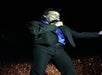 Dressed in a sharp black suit and silky blue shirt and microphone in hand, Travis James electrifies the stage with his performance.
