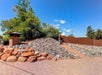 An outdoor courtyard with a meditating Thai Buddha statue surrounded by rocks at the Aiden by Best Western in Sedona.