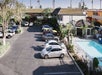 Parking area and the outdoor pool at Alamo Inn and Suites Anaheim, CA.