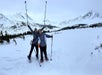 Two women pose in their jackets and snowshoe gear
