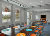 Meeting facility with tables, chairs and a flat-screen TV.
